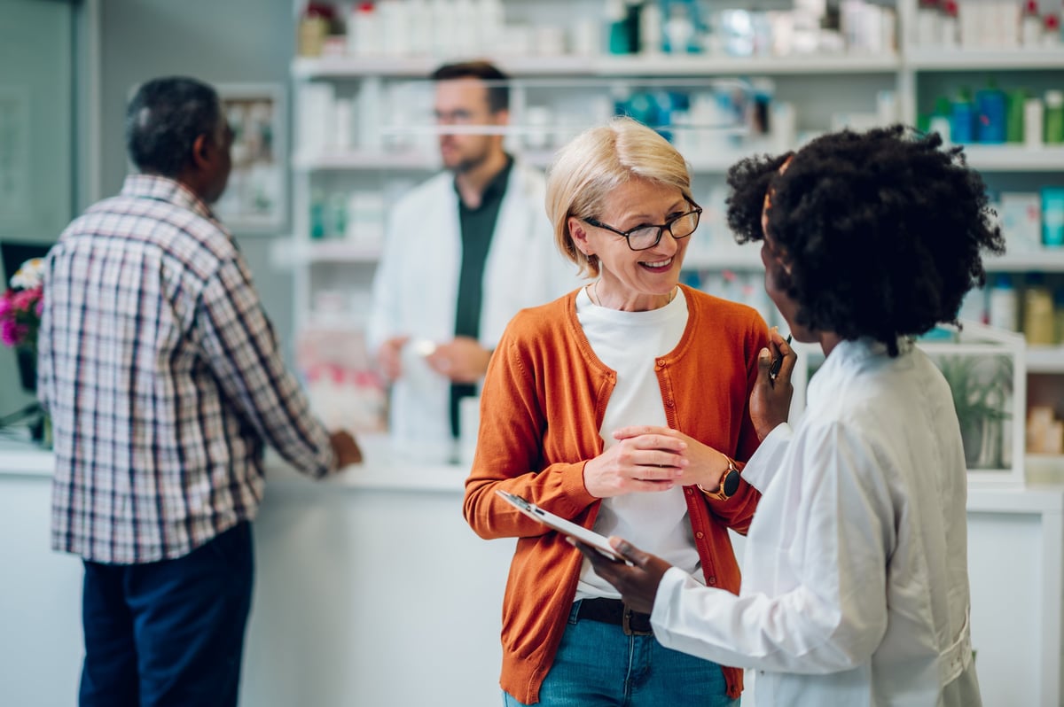 Pharmacist advising a customer about medications