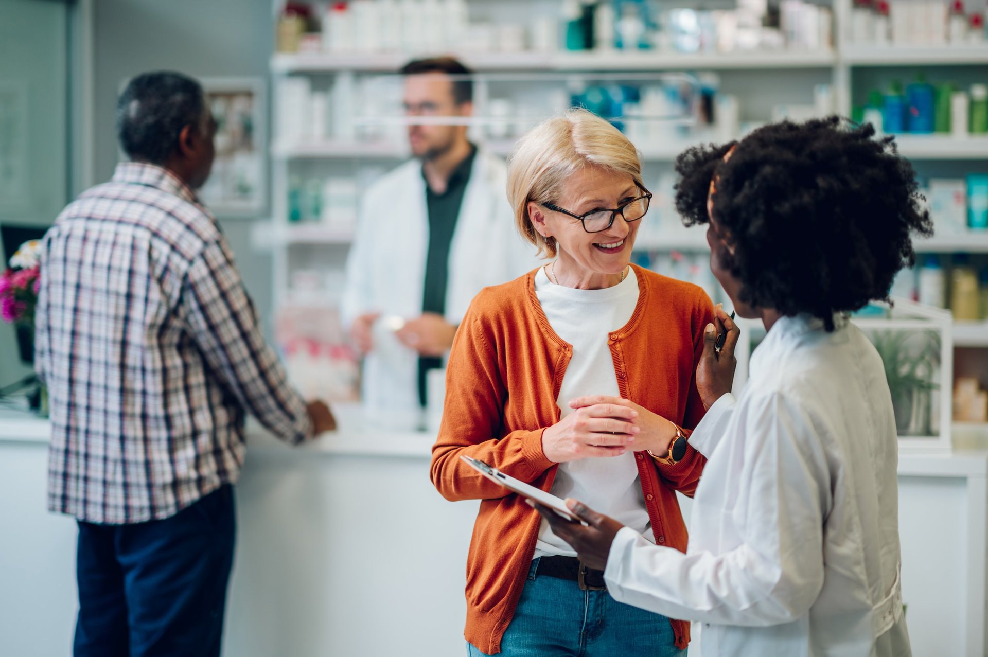 Pharmacist advising a customer about medications