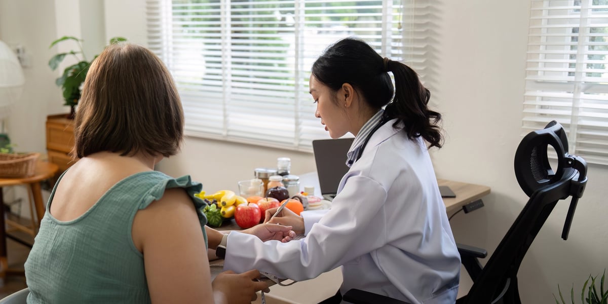 A nutritionist advising a client on a balanced diet in a comforting environment