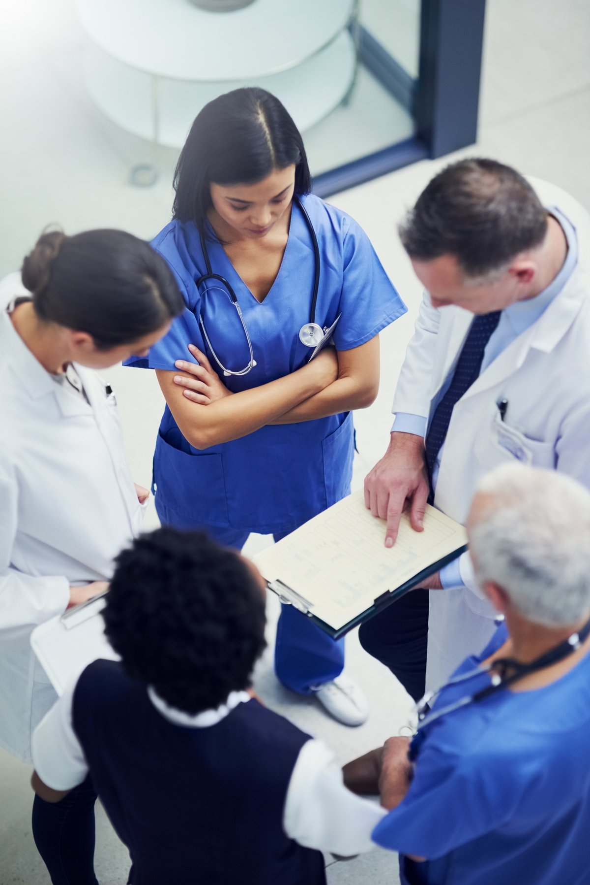Group of healthcare practitioners discussing a patient